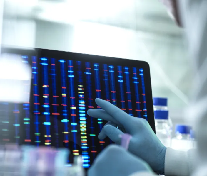 Scientist examining DNA (deoxyribonucleic acid) results on a screen during an experiment in the laboratory.